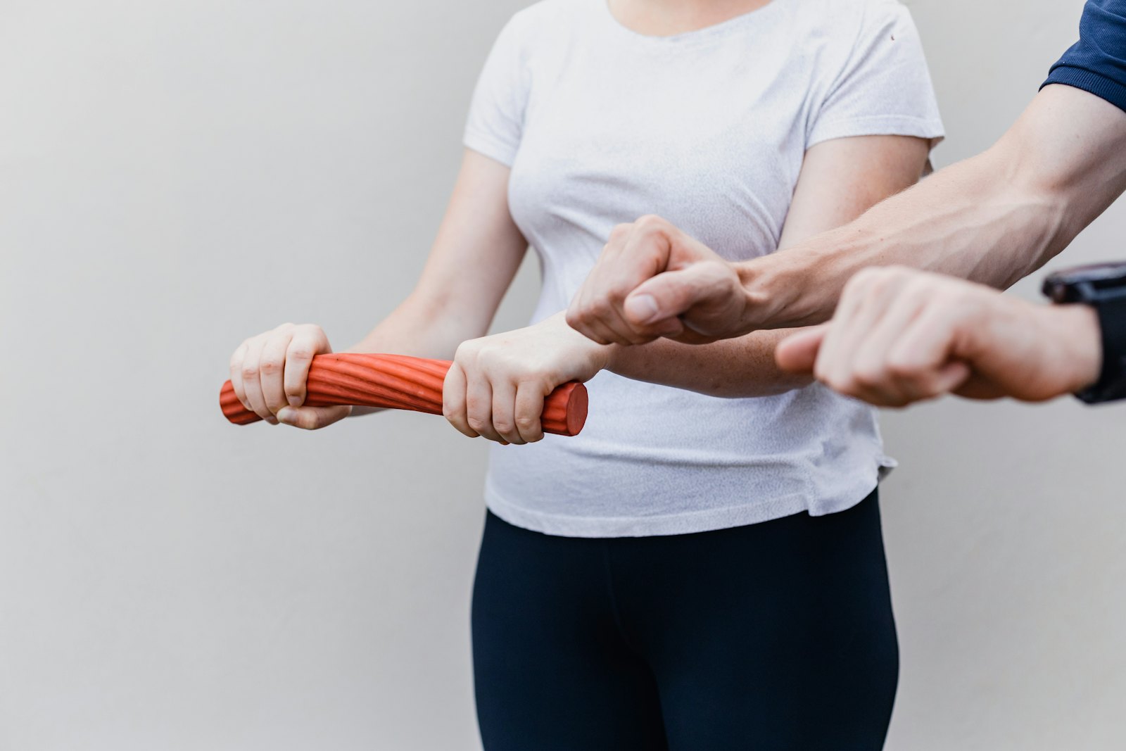 Physiotherapist guiding a patient's arm during a rehab exercise